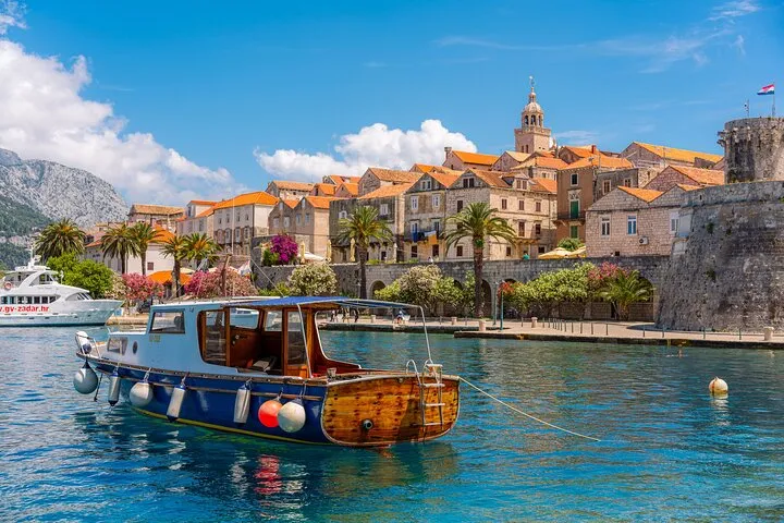 Restored wooden boat MIAMI anchored off a green islet on the Sail Away Korcula archipelago cruise in Croatia